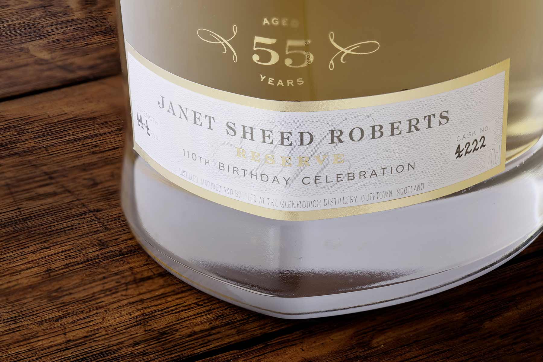 Glenfiddich 55 year old JANET SHEED ROBERTS RESERVE Bottle on wood table