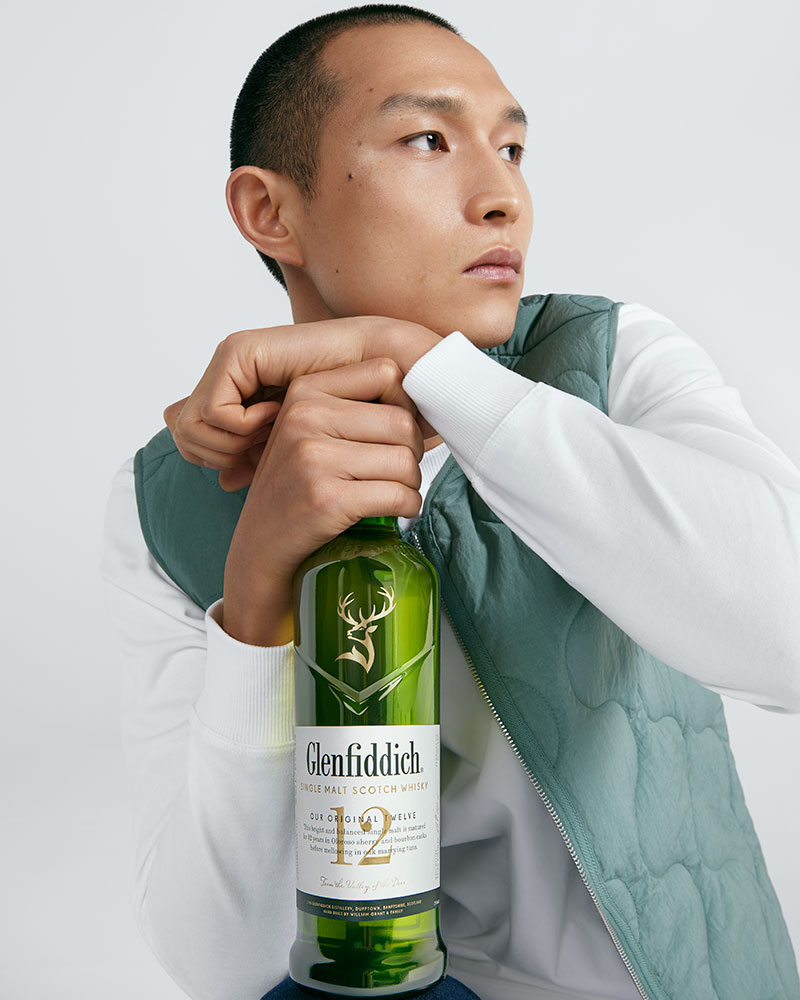 Man holding bottle of Glenfiddich 12 Year Old Single Malt Scoth Whisky