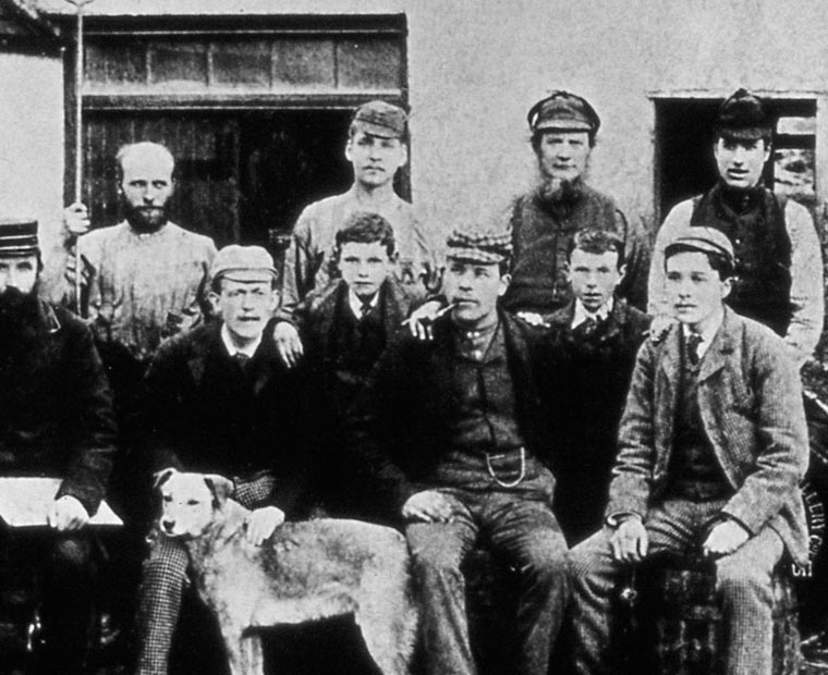 Historic black and white photo of distillery workers