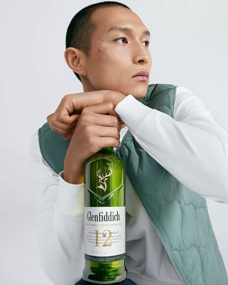 Man holding bottle of Glenfiddich 12 Year Old Single Malt Scoth Whisky