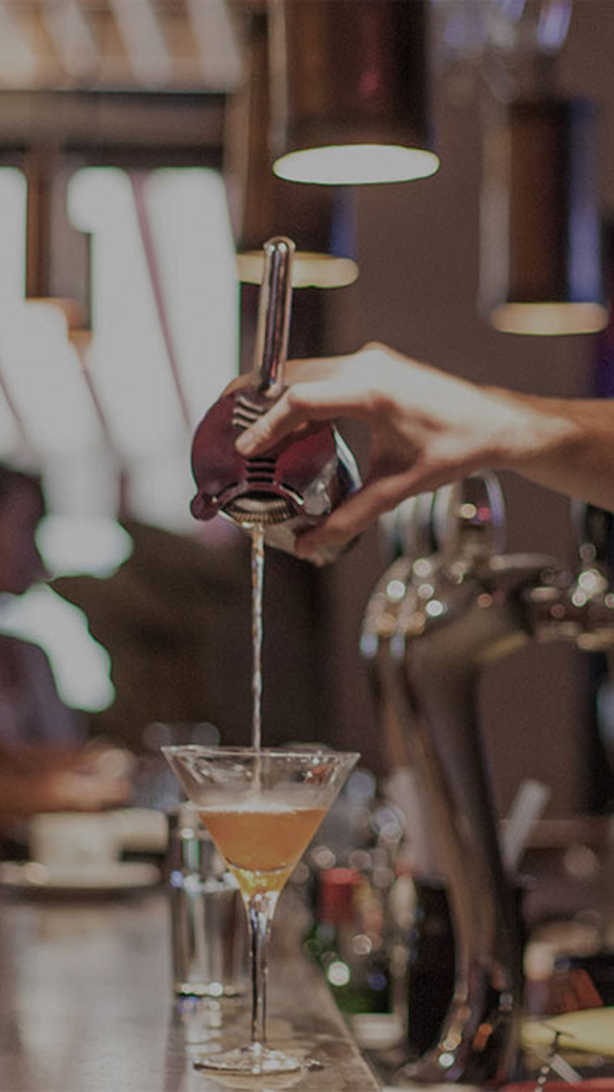 Man pouring whisky cocktail