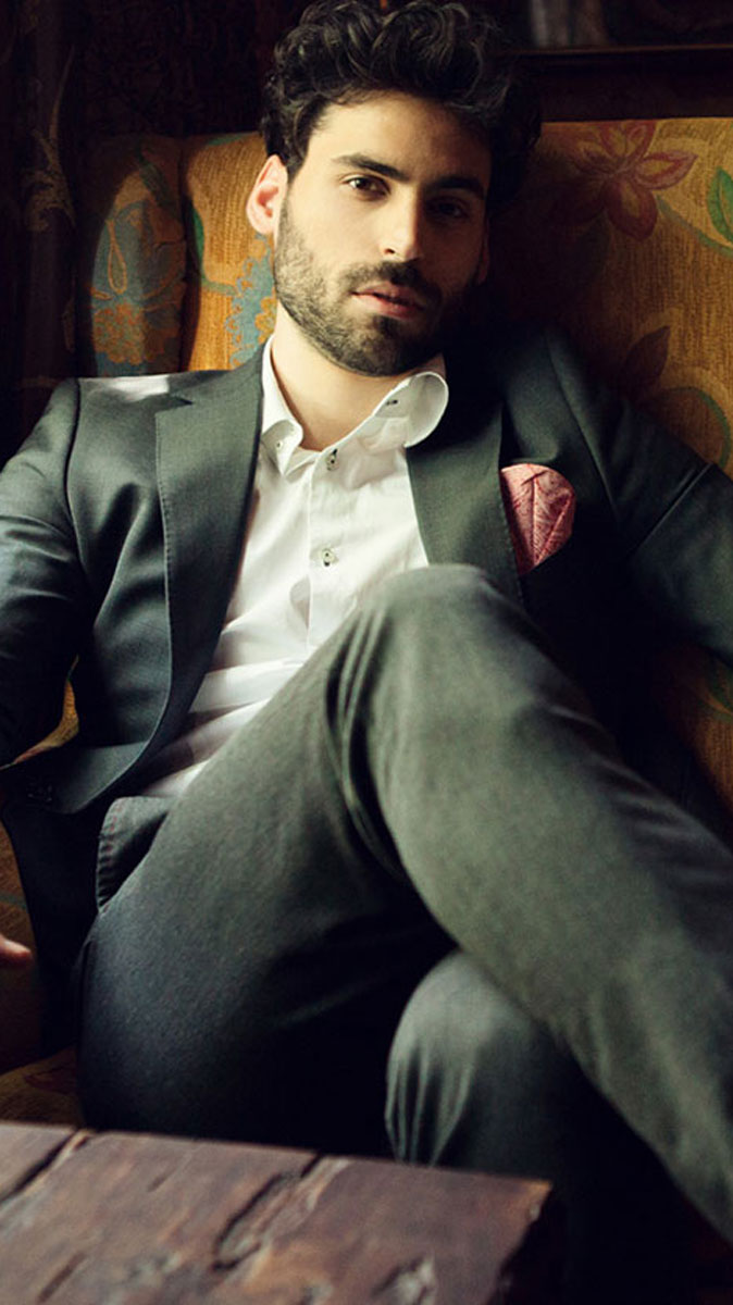 Man in suit sitting in chair