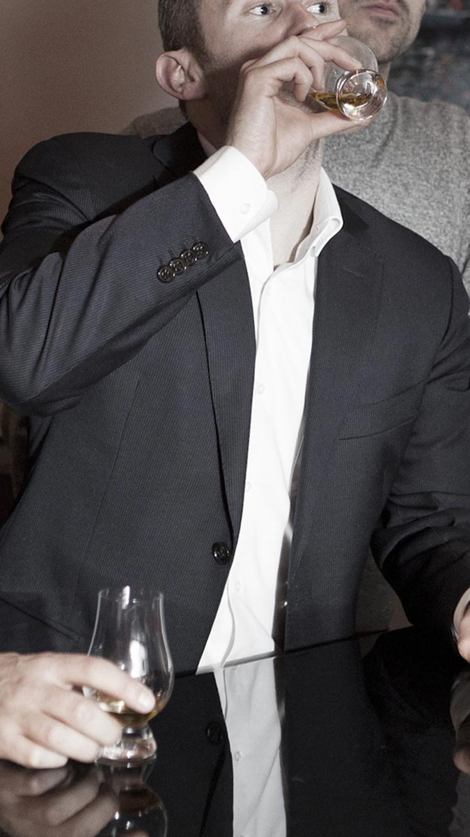 Men in suits drinking whisky