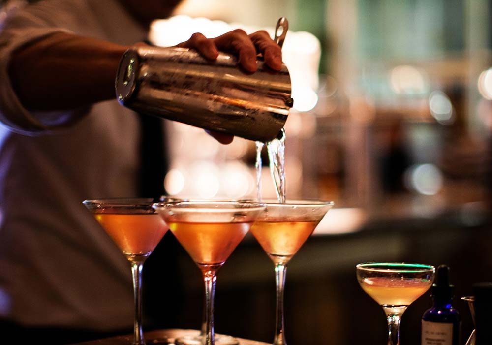 Bartender pouring cocktails