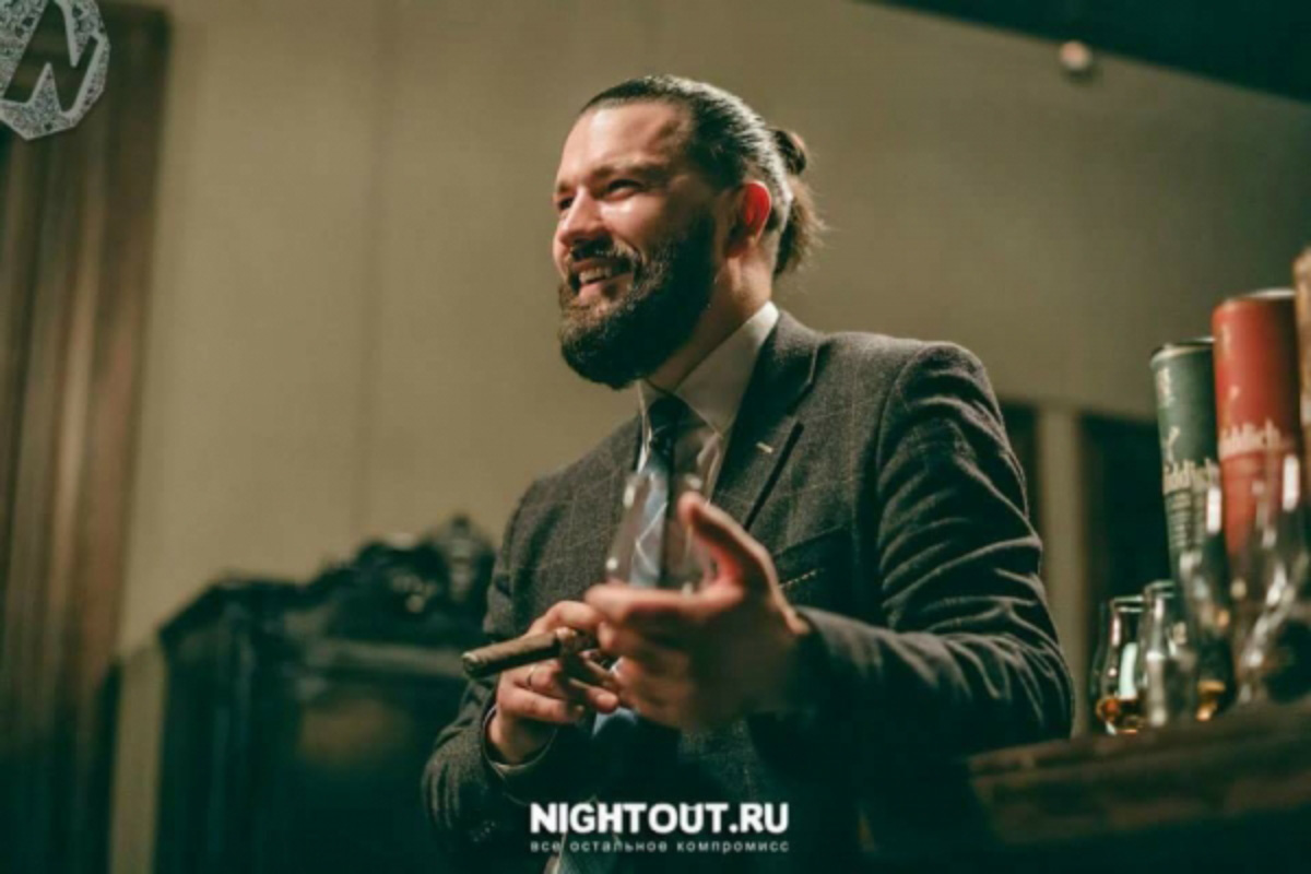 Man in suit holding cigar