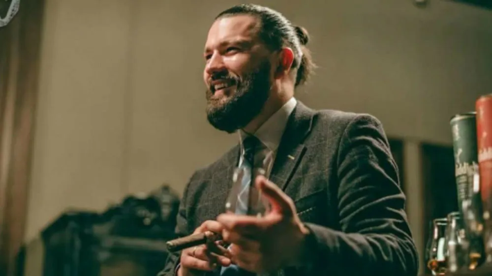 Man in suit holding cigar