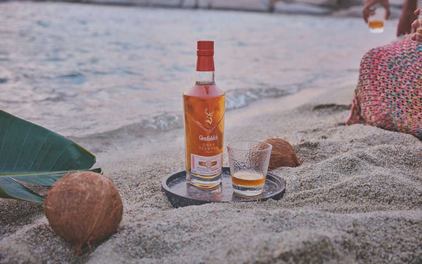 Glenfiddich 21 Year Old Gran Reserva Whisky bottle on the beach